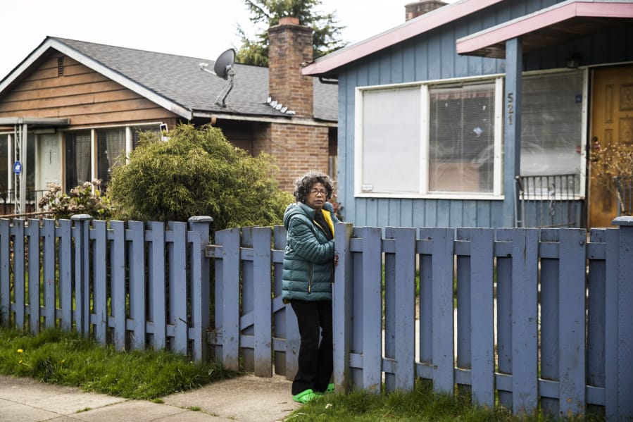 Ruby Holland outside her home in Seattle&#039;s Central District on April 3, 2020. Holland had received offers for her house many times before, but now she&#039;s worried as real estate investors are swooping in during these hard times due to the coronavirus pandemic.