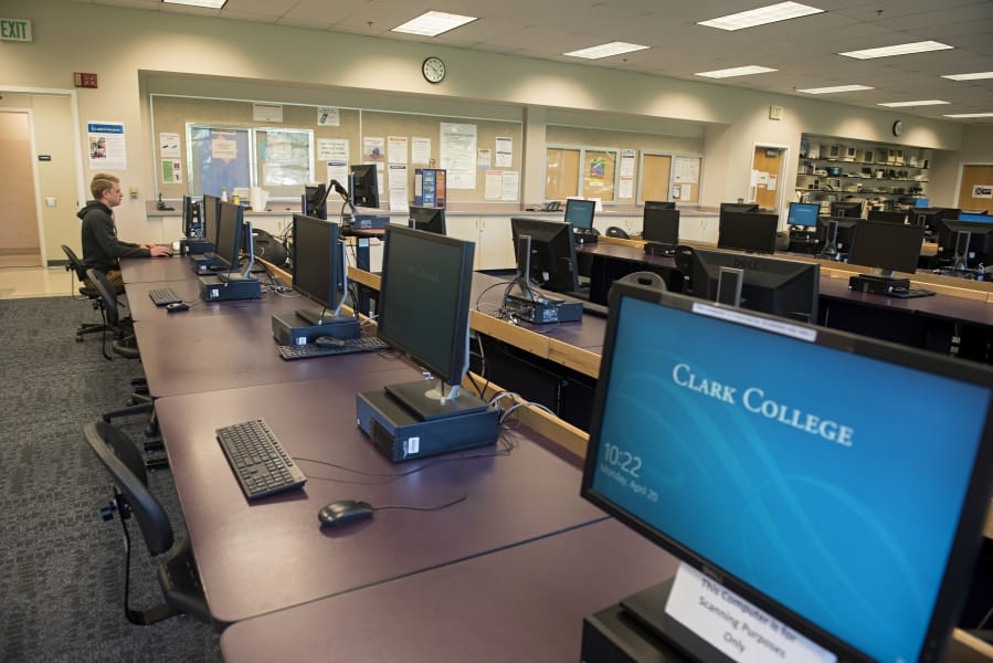 Clark College student Alex Belza, 16, works in an empty computer lab at Scarpelli Hall that allowed extra space for social distancing on Monday morning. Clark College announced on Friday it would extend distance learning through the fall quarter.