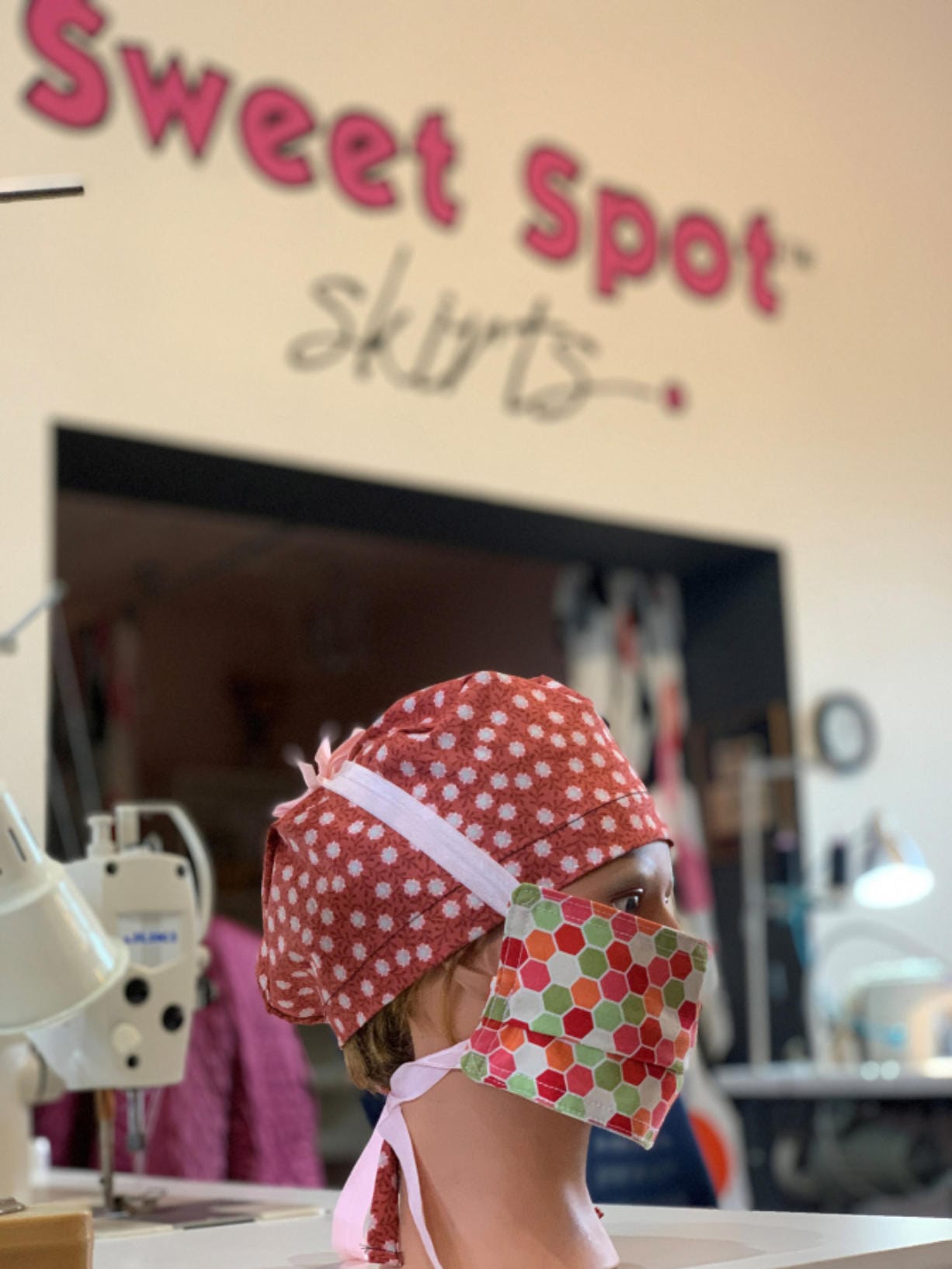 A mannequin head is outfitted with a new mask and cap at Sweet Spot Skirts in Vancouver. The local retailer has begun manufacturing cloth masks after WellHaven Pet Health began ordering them for veterinarians at its clinics.