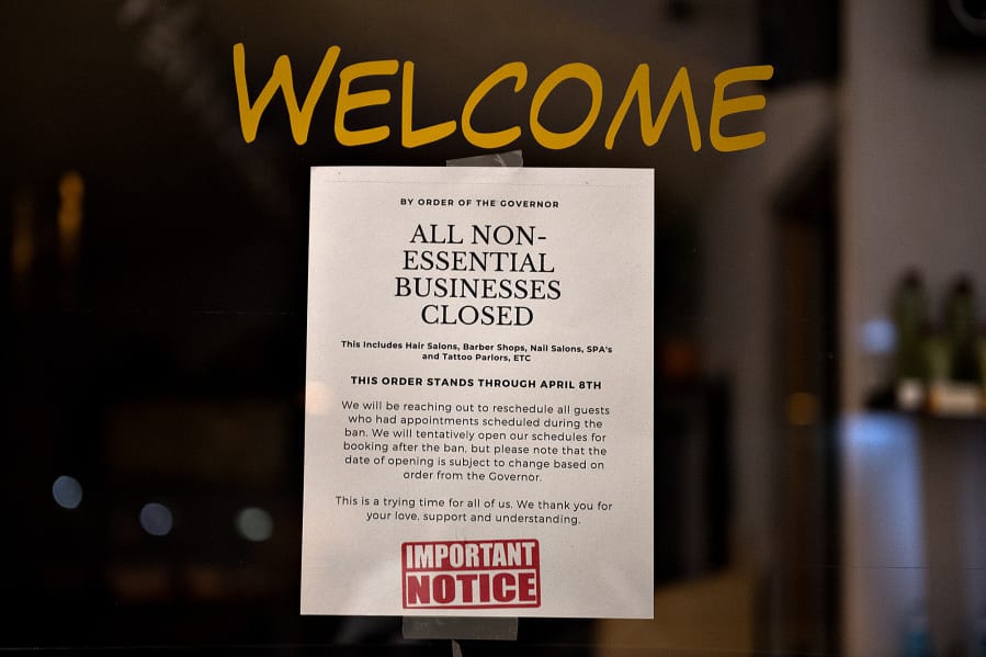 A sign on a business considered &quot;nonessential&quot; by the state notifies customers of its closure in downtown Vancouver late last month.