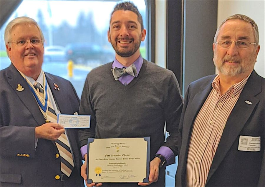 VANCOUVER: Jeff Lightburn, left, and Tom Boardman, right, of the Fort Vancouver Sons of the American Revolution Chapter, present John Zingale his SAR History Teacher of the Year Certificate and $200 check.