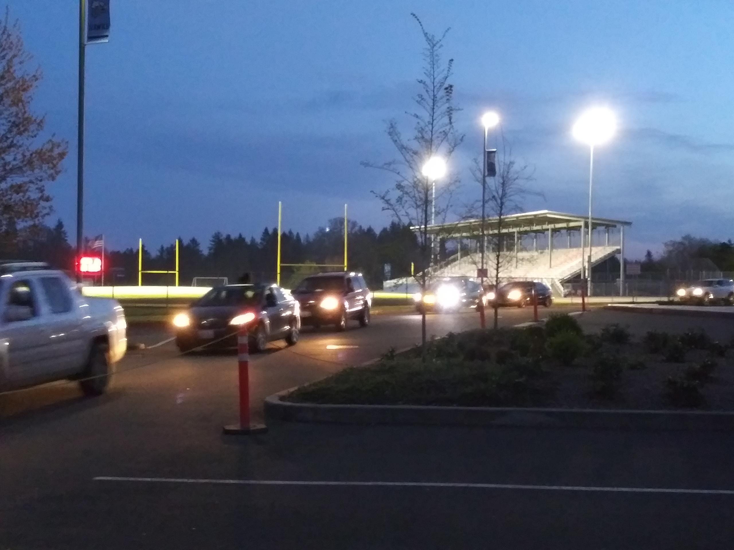 Cars file past Hockinson High School's stadium on #BeTheLightWA night on Friday (Tim Martinez/The Columbian)