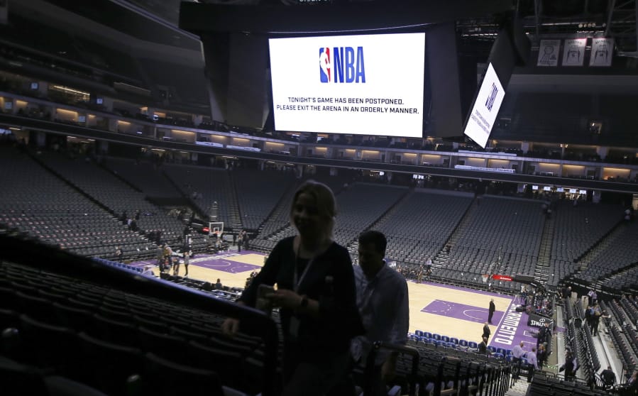 Fans leave the Golden 1 Center after the NBA basketball game between the New Orleans Pelicans and Sacramento Kings was postponed at the last minute in Sacramento, Calif., Wednesday, March 11, 2020. The league said the decision was made out of an &quot;abundance of caution,&quot; because official Courtney Kirkland, who was scheduled to work the game, had worked the Utah Jazz game earlier in the week. A player for the Jazz tested positive for the coronavirus.
