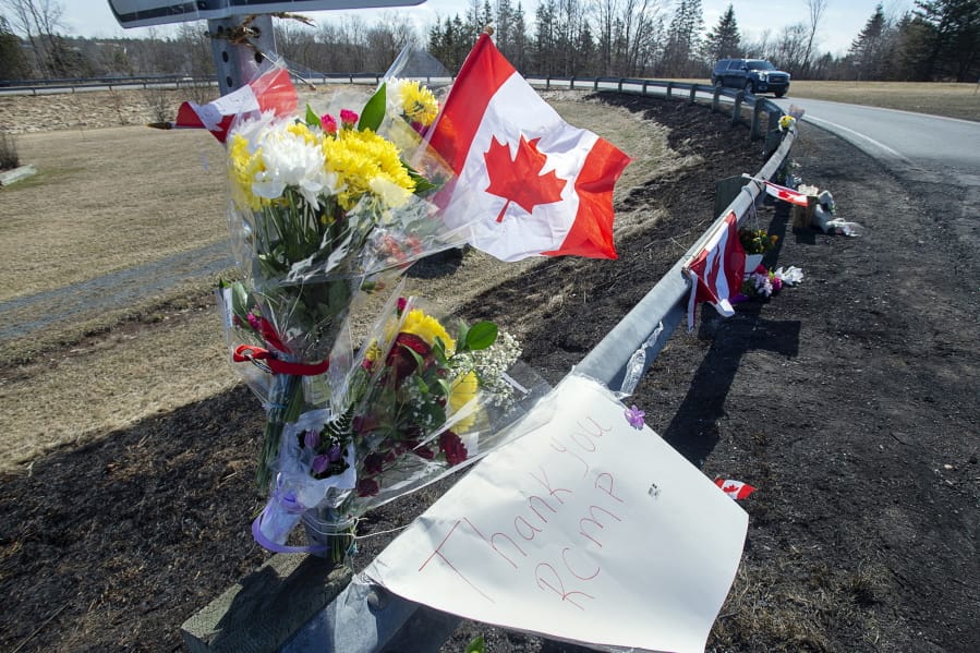 A memorial pays tribute to Royal Canadian Mounted Police Constable Heidi Stevenson, a mother of two and a 23-year veteran of the force, along the highway in Shubenacadie, Nova Scotia, on Tuesday, April 21, 2020. Canadian police are investigating at 16 crime scenes after a weekend rampage by a gunman disguised as a police officer left at least 18 dead, including Stevenson, and homes in smoldering ruins in rural communities across Nova Scotia.
