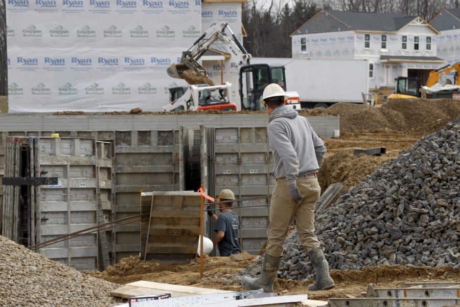 In this March 18 ,2020 photo, construction continues at a housing plan in Zelienople, Pa. Spending on U.S. construction projects fell 1.3% in February with housing and nonresidential construction both showing weakness even before the coronavirus struck with force in the United States. The Commerce Department said the February decline followed a 2.8% rise in construction in January.
