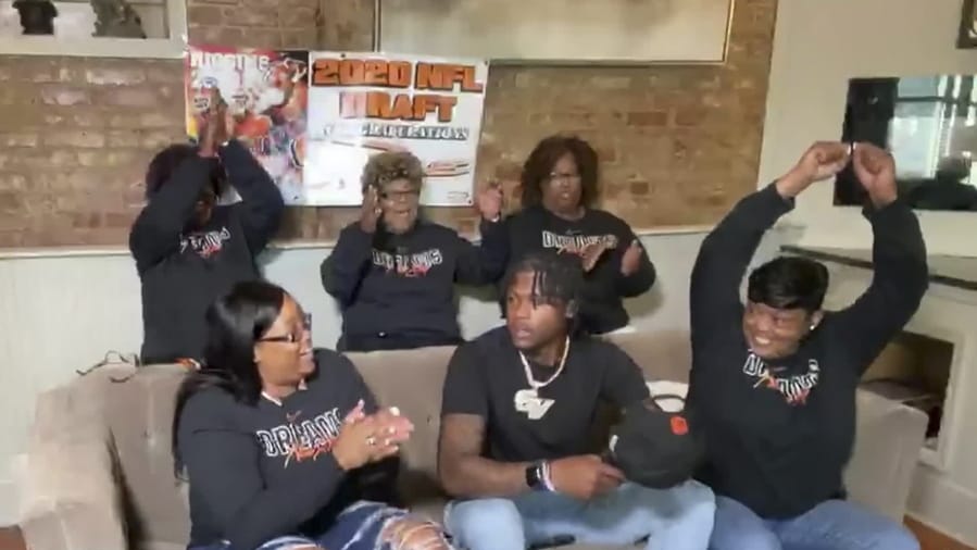 In this still image from video provided by the NFL, Tee Higgins, front center, is selected by the Cincinnati Bengals in the second round of the NFL football draft, Friday, April 24, 2020.
