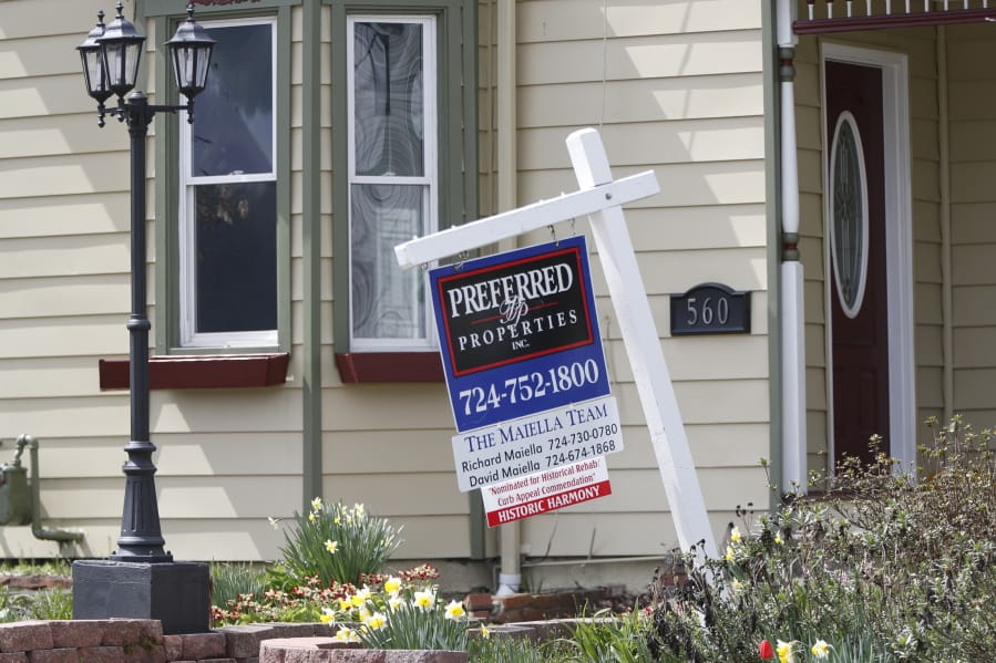This April 16, 2020 photo shows a real estate company sign that marks a home for sale in Harmony, Pa.  U.S. new home sales plunged 15.4% in March as the lockdowns that began in the middle of the month began to rattle the housing market.