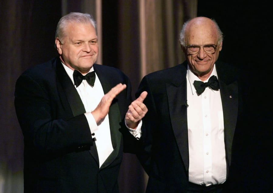 FILE - In this June 6, 1999 file photo, actor Brian Dennehy, left, applauds playwright, Arthur Miller, before awarding him the Lifetime Achievement Award at the Tony Awards in New York. Dennehy, the burly actor who started in films and later in his career won plaudits for his stage work in plays, died of natural causes on Wednesday, April 15, 2020 in New Haven, Conn. He was 81.