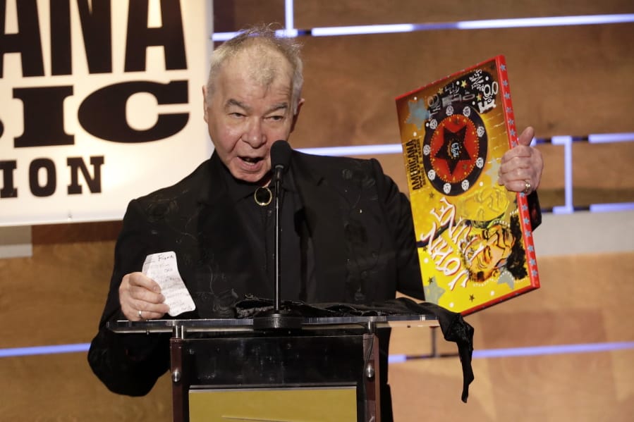 FILE - In this Sept. 11, 2019 file photo, John Prine accepts the Album of the Year award at the Americana Honors &amp; Awards show in Nashville, Tenn. Prine died Tuesday, April 7, 2020, from complications of the coronavirus. He was 73.