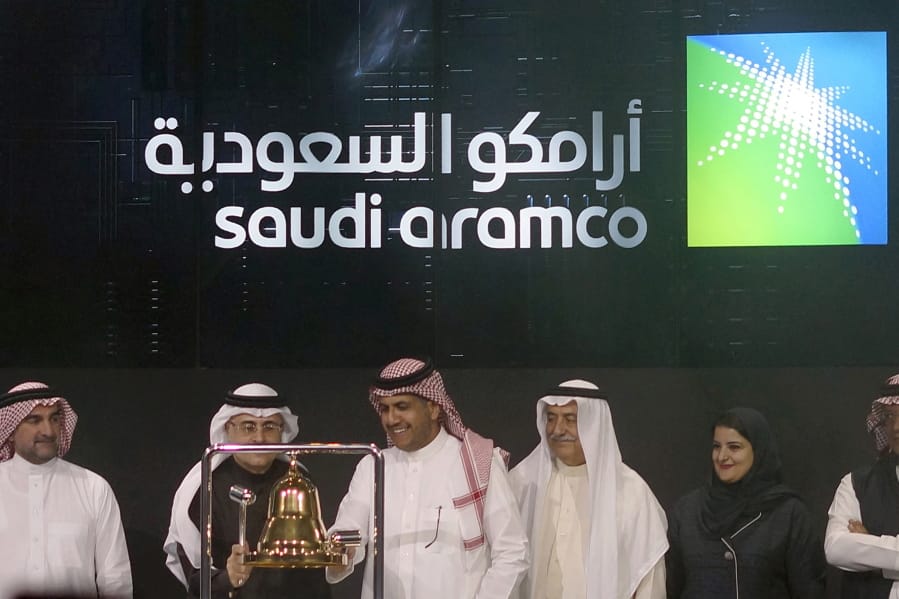 FILE - In this Dec. 11, 2019, file photo, Saudi Arabia&#039;s state-owned oil company Armco and stock market officials celebrate during the official ceremony marking the debut of Aramco&#039;s initial public offering (IPO) on the Riyadh&#039;s stock market, in Riyadh, Saudi Arabia. Saudi Arabia&#039;s oil company Aramco said Wednesday, march 11, 2020, it will increase production capacity to 13 million barrels per day, up from 12 million per day, part of a strategy to dominate market share amid a slowdown in demand due to the outbreak of a new virus.