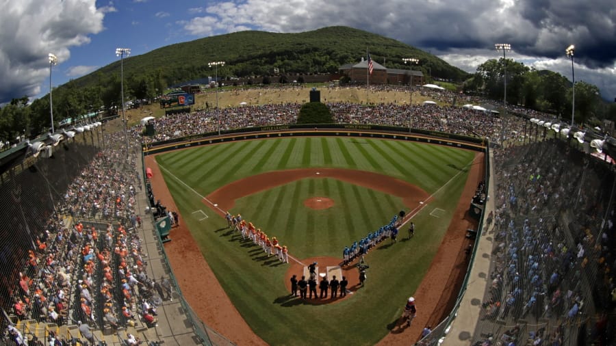 River Ridge, La., lines the third baseline and Curacao lines the first baseline during team introductions before the 2019 Little League World Series Championship game at Lamade Stadium in South Williamsport, Pa. (AP Photo/Gene J.
