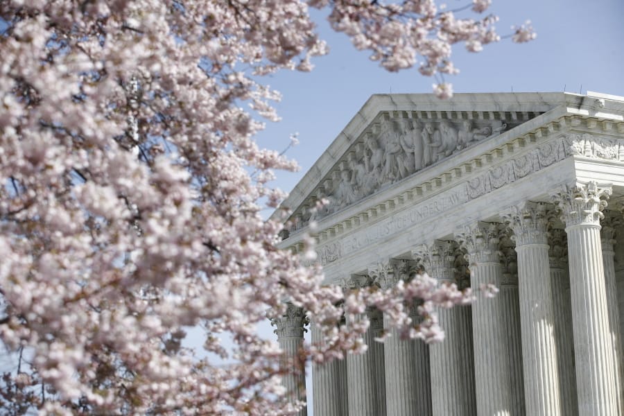 In this March 16, 2020 photo, a tree blooms outside the Supreme Court in Washington, Monday, March 16, 2020.