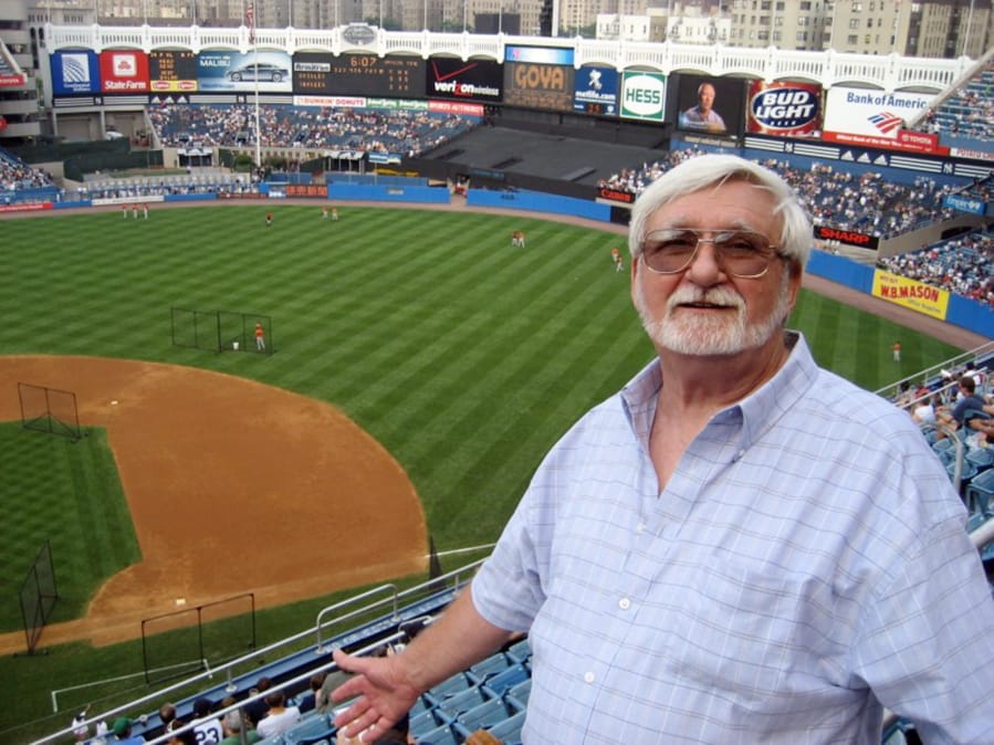 In this 2008 photo provided by John Pijanowski, Pijanowski&#039;s father Don Pijanowski, who died of COVID-19 on April 1, 2020, poses during his first visit to Yankee Stadium in New York.  Unable to be with their father during his final moments, Pijanowski&#039;s sons asked a nurse at a hospital in Buffalo, N.Y., to tell him they loved him.