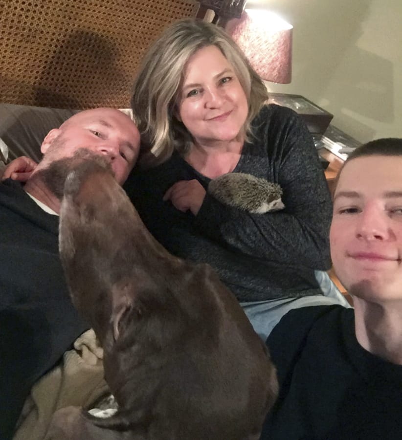 The Pavlik family, Matthew, Rachael, their son Henry, hedgehog Quillie Nelson and German shorthair pointer Mudge, poses April 2 for a photo in their home in Sugar Land, Texas. Many pet owners are taking comfort in their animals as they shelter at home amid the coronavirus pandemic.