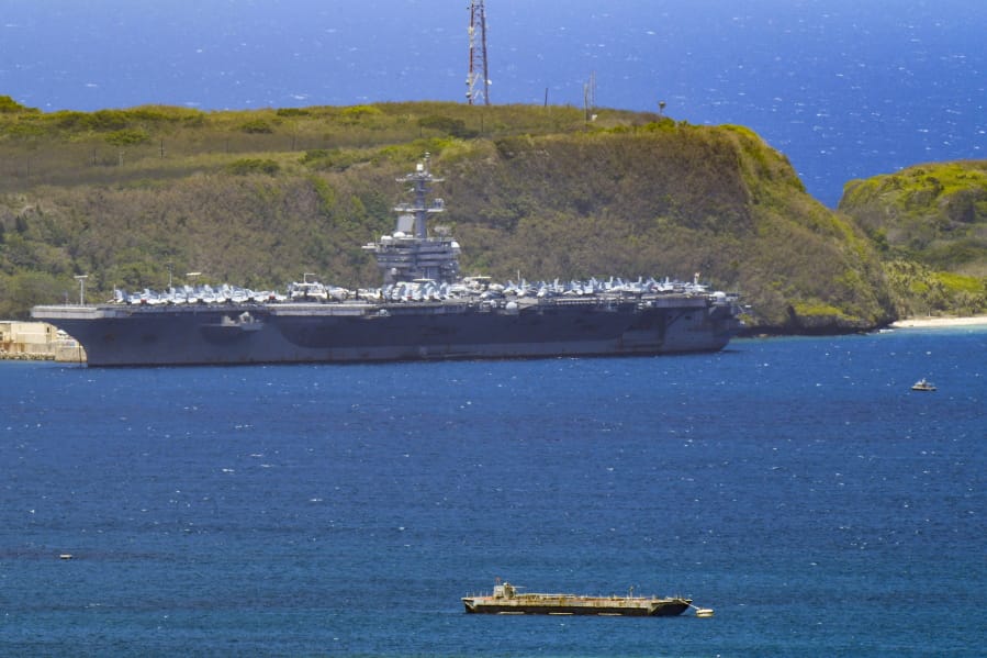The USS Theodore Roosevelt, a Nimitz-class nuclear powered aircraft carrier, is docked along Kilo Wharf of Naval Base Guam in Sumay,  Friday, April 3, 2020. The aircraft carrier, with a crew of nearly 5,000, is docked in Guam, and the Navy has said as many as 3,000 will be taken off the ship and quarantined by Friday. More than 100 sailors on the ship have tested positive for the virus, but none is hospitalized.