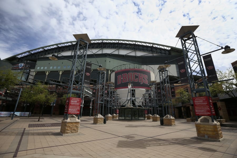The main entrance in front of Chase Field is devoid of activity in Phoenix. Putting all 30 teams in the Phoenix area this season and playing in empty ballparks was among the ideas discussed Monday, April 6, 2020 during a call among five top officials from MLB and the players&#039; association that was led by Commissioner Rob Manfred, people familiar with the discussion told The Associated Press.  (AP Photo/Ross D.
