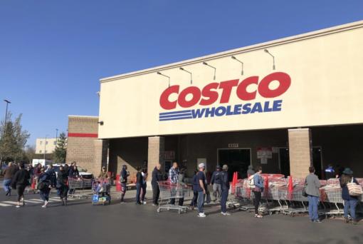 FILE - In this March 20, 2020 file photo, shoppers line up to enter a Costco store in Tacoma.  (AP Photo/Ted S.