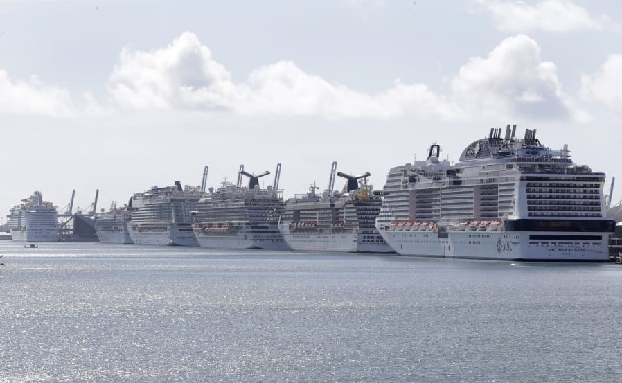 Cruise ships are docked at PortMiami, Tuesday, March 31, 2020, in Miami.