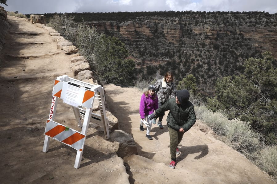 Shelly Clayton, center, walks up the Bright Angel Trail March 27 at Grand Canyon National Park, Ariz., with her children Audrey Kuhar, 11, left, and Cooper Kuhar, 11.