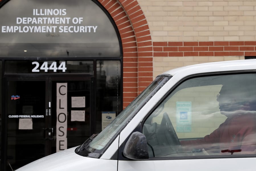 A man looks at the closed sign in front of Illinois Department of Employment Security in Chicago, Wednesday, April 15, 2020. With half-a-million people bounced out of jobs in the past month because of the COVID-19 pandemic, Illinois&#039; unemployment safety net has been stretched to the limit. (AP Photo/Nam Y.