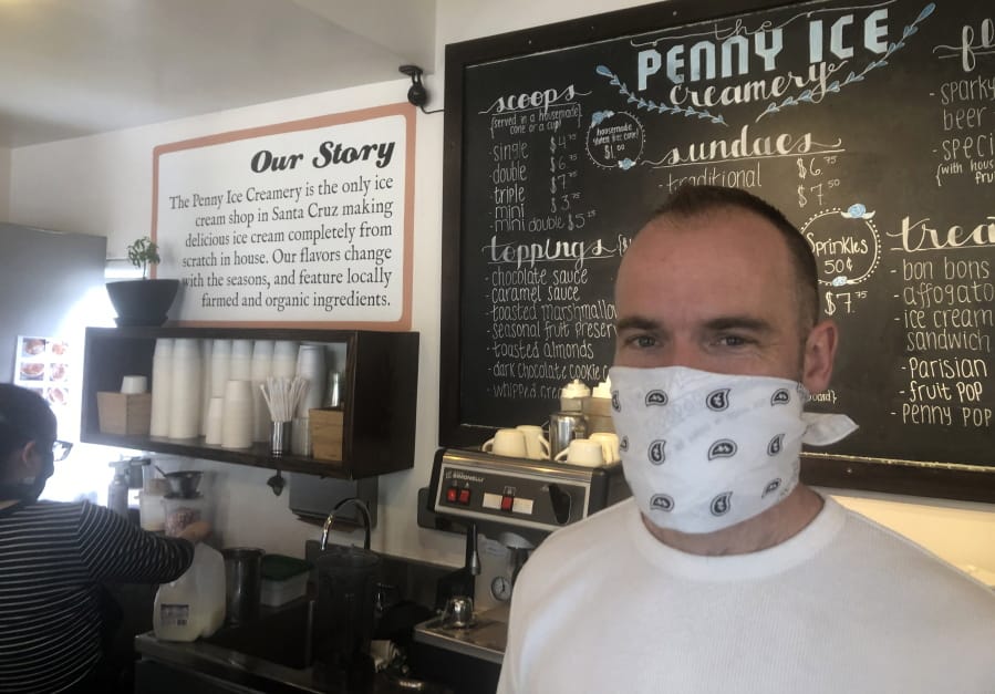 In this April 17, 2020, photo, Zachary Davis poses for a photo at The Penny Ice Creamery in Santa Cruz, Calif. An investigation by The Associated Press found that the federal Paycheck Protection Program, which was supposed to provide small businesses like Davis&#039; with access to cash to support their employees, also provided hundreds of millions of dollars to large publicly traded companies.