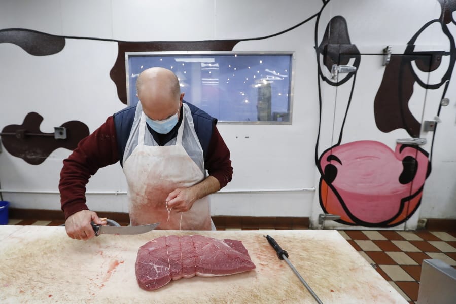 John Warminski prepares meat at Ronnie&#039;s Quality Meats in Detroit Wednesday, April 29, 2020. President Donald Trump has ordered meat processing plants to stay open amid concerns over growing coronavirus COVID-19 cases and the impact on the nation&#039;s food supply.