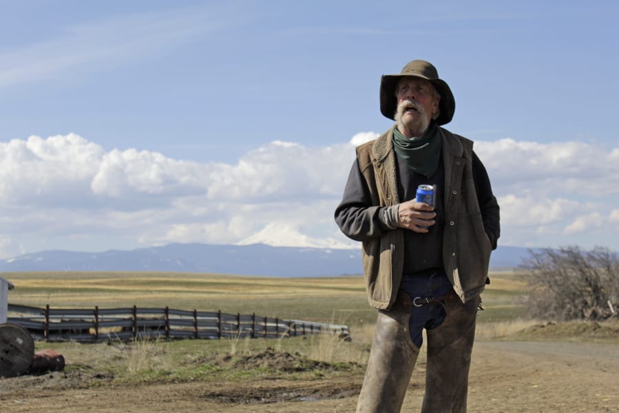 In this photo taken March 20, 2020, cattle rancher Mike Filbin stands on his property in Dufur, Ore., after herding some cows and talks about the impact the new coronavirus is having on his rural community. Tiny towns tucked into Oregon&#039;s windswept plains and cattle ranches miles from anywhere in South Dakota might not have had a single case of the new coronavirus yet, but their residents fear the spread of the disease to areas with scarce medical resources, the social isolation that comes when the only diner in town closes its doors and the economic free fall that&#039;s already hitting them hard.