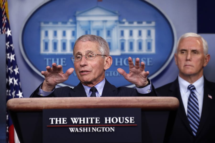 Dr. Anthony Fauci, director of the National Institute of Allergy and Infectious Diseases, speaks about the coronavirus in the James Brady Press Briefing Room of the White House, Wednesday, April 1, 2020, in Washington, as Vice President Mike Pence listens.