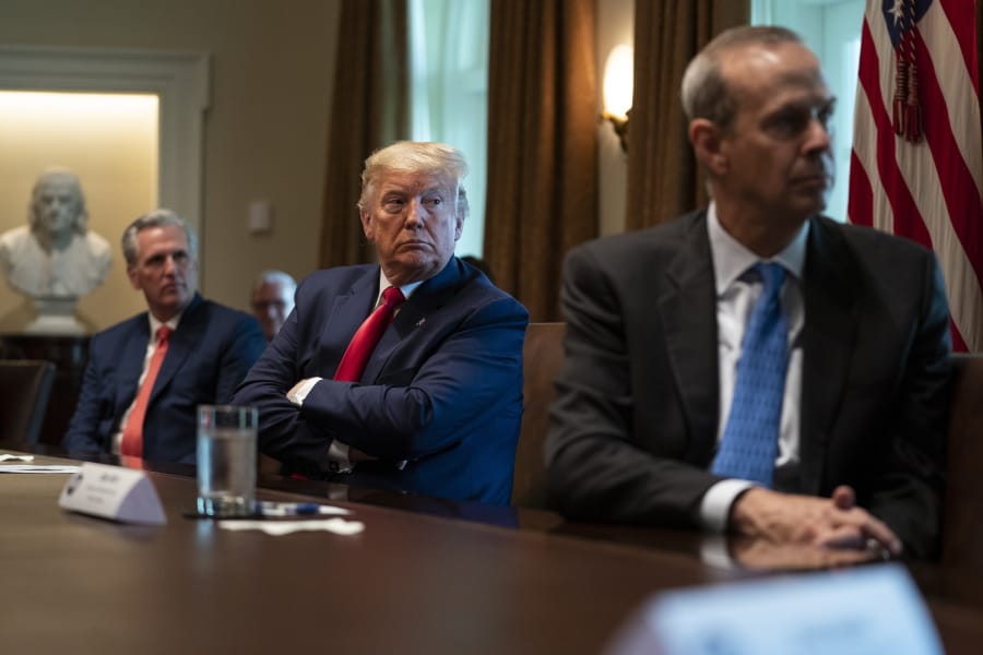 House Minority Leader Kevin McCarthy of Calif., President Donald Trump, and Chevron CEO Mike Wirth listen during a meeting with energy sector business leaders in the Cabinet Room of the White House, Friday, April 3, 2020, in Washington.