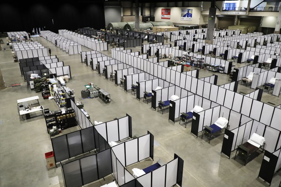 Rows of patient beds are shown at a military field hospital, Sunday, April 5, 2020, at the CenturyLink Field Event Center in Seattle. Officials said the facility, which will be used for people with medical issues that are not related to the new coronavirus outbreak, has more than 200 beds and is ready now to receive patients. (AP Photo/Ted S.