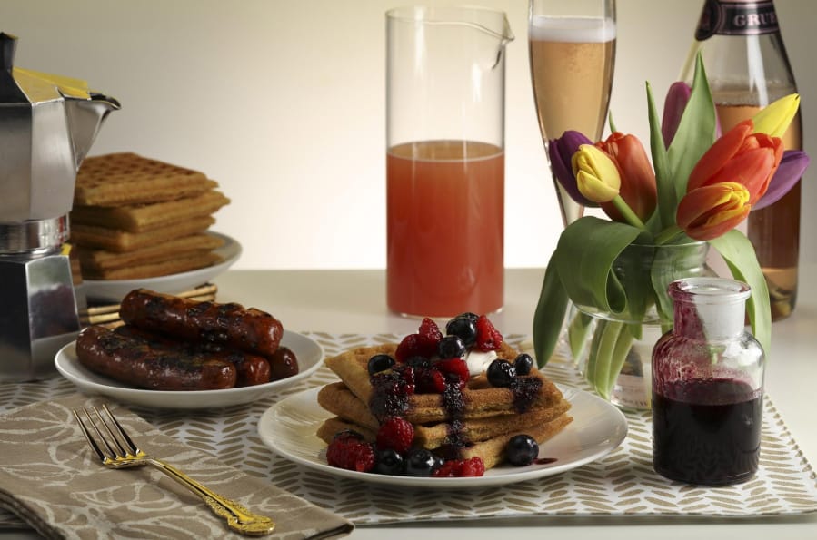 Serve the cornmeal waffles with the pineapple orange compote, or use fresh berries and blueberry syrup. Chicken breakfast sausages, a grapefruit and sparkling rose mimosa, and plenty of coffee round out the meal.