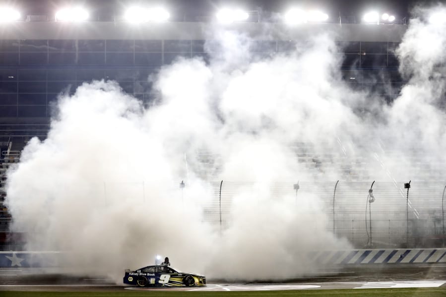 Chase Elliott does a burnout after winning the NASCAR Cup race Thursday at Charlotte Motor Speedway.