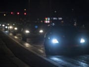 Motorists with bright headlights navigate an intersection near Vancouver Mall.