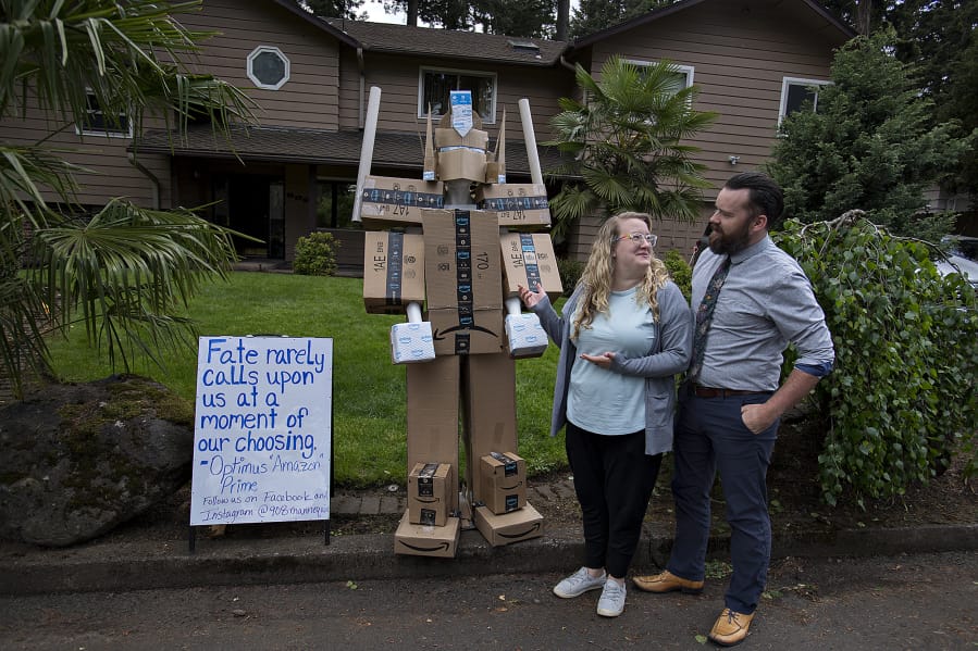Kaaren and Daniel Spanski-Dreffin of Vancouver look over their mannequin dressed up as Optimus &quot;Amazon&quot; Prime in the front yard of their home Monday afternoon. The couple change his theme daily, to the delight of their neighbors. &quot;The whole idea is to make people laugh,&quot; Daniel Spanski-Dreffin said.