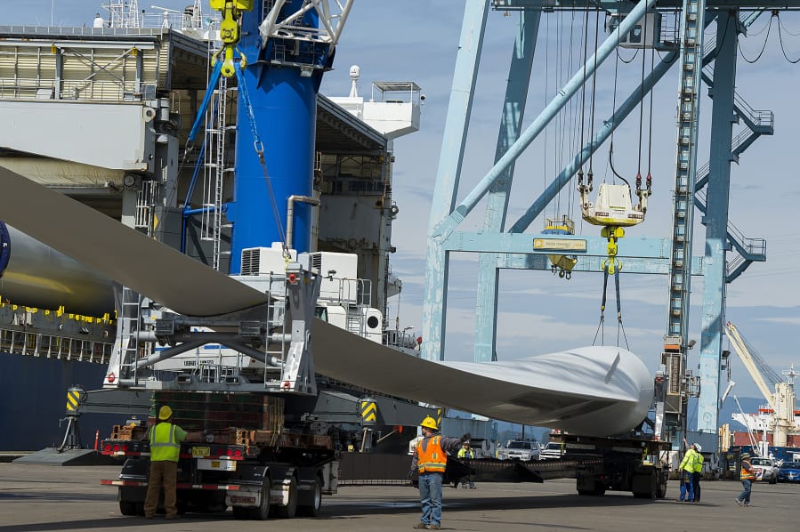 Workers unload wind blades bound for Canada from the MV Star Kilimanjaro at the Port of Vancouver on Monday morning. The ship departed China on April 13 and held 27 blades for nine wind turbines.