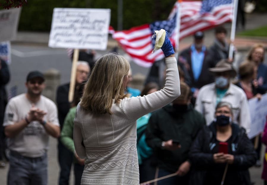 State Rep. Vicki Kraft, R-Vancouver, speaks to a crowd gathered in front of Clark County Courthouse to protest Washington Governor Jay Inslee&#039;s extension of coronavirus stay-at-home order in Vancouver on Friday.