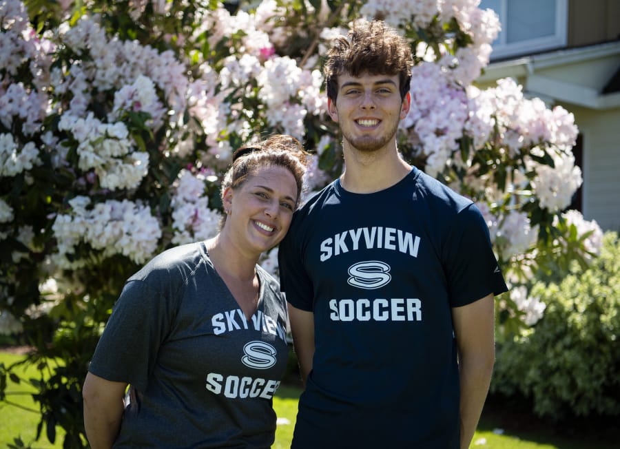 Skyview High School teacher and soccer coach Colleen McKinney and her son, senior Cody McKinney, right, are pictured at their home in Vancouver on Friday, May 8, 2020.