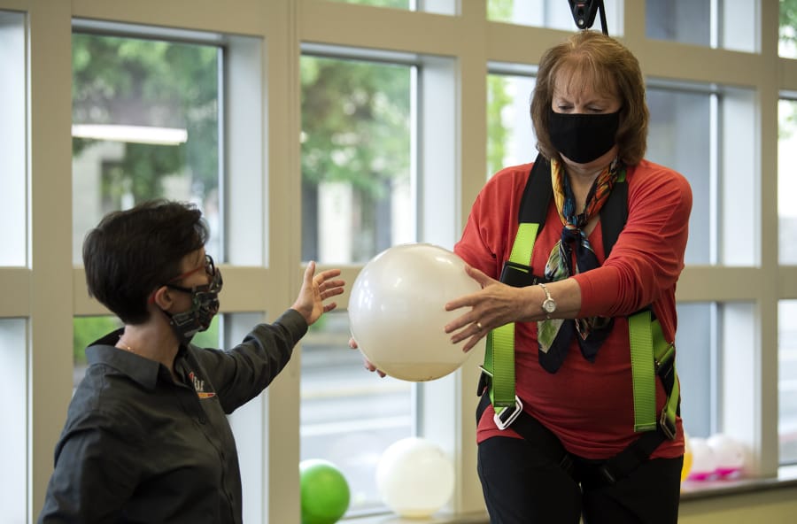 Boomerang Therapy Works co-owner and physical therapist JJ Flentke, left, works with patient Nancy Warren in Vancouver. The office opened back up on May 1 after six weeks of telehealth visits. They are taking extra safety precautions, with more frequent sanitizing, physical distancing and requiring people to wear a mask.