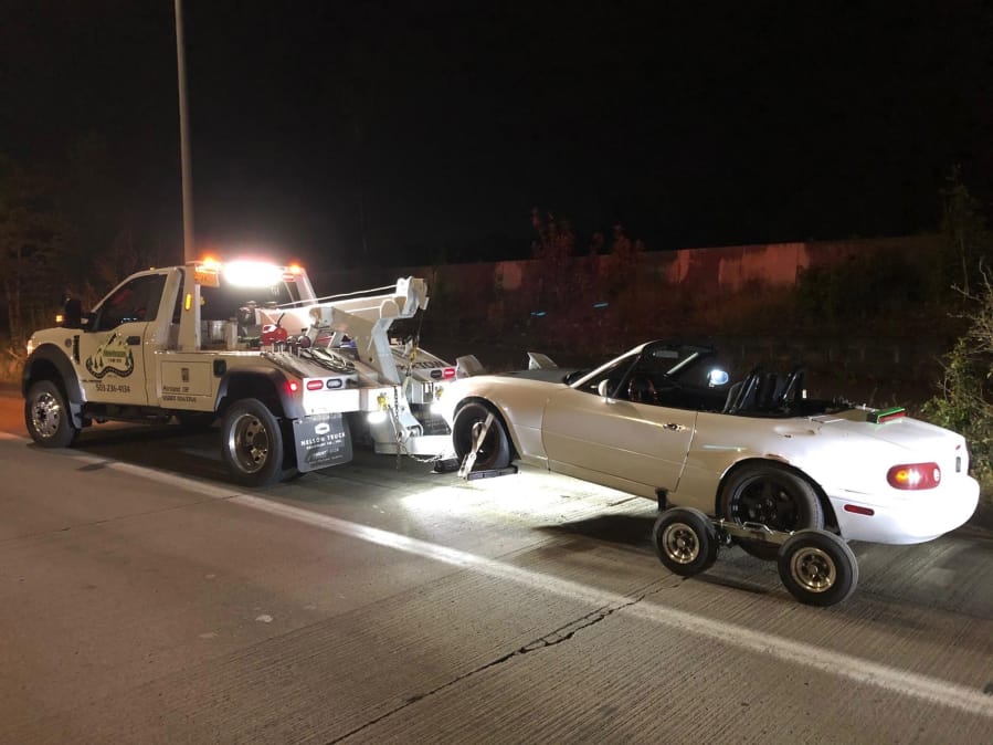 A white Mazda Miata allegedly used in street racing is impounded by Portland Police on April 19. A man from Ridgefield was one of four suspects arrested in connection with the incident.