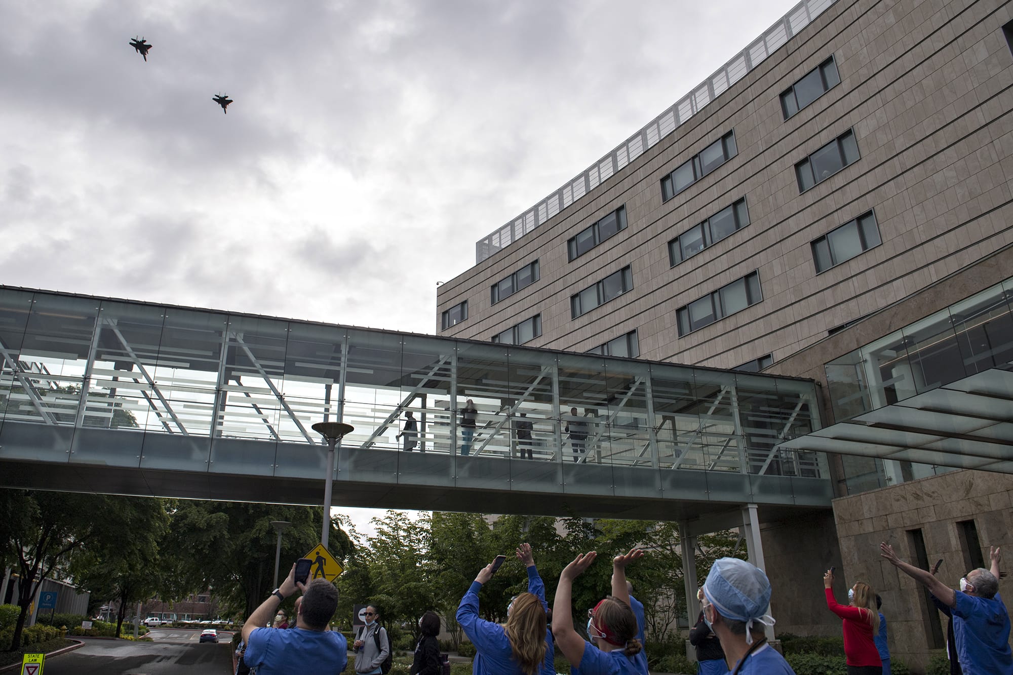 Pilots from the Oregon Air National Guard honor health care workers, first responders, and other essential staff who are working to keep local residents safe with a flyover at Legacy Salmon Creek Medical Center on Friday morning. The tribute, which traveled west to east over the facility, continued on to visit other hospitals in the region.
