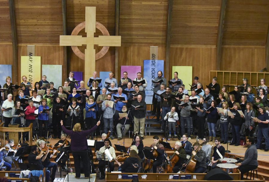 The Vancouver Master Chorale, plus full orchestra, squeezes together during a rehearsal at First Presbyterian Church in Vancouver. The physical closeness seen here is a good example of why choirs now see no choice but to wait out the end of the coronavirus pandemic.