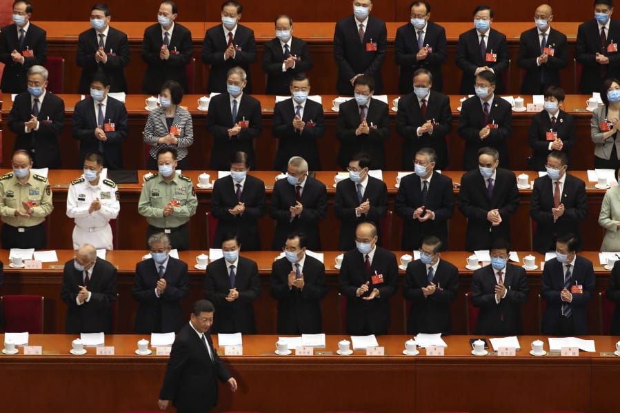 Delegates applaud as Chinese President Xi Jinping arrives for the opening session of China&#039;s National People&#039;s Congress (NPC) at the Great Hall of the People in Beijing, Friday, May 22, 2020.