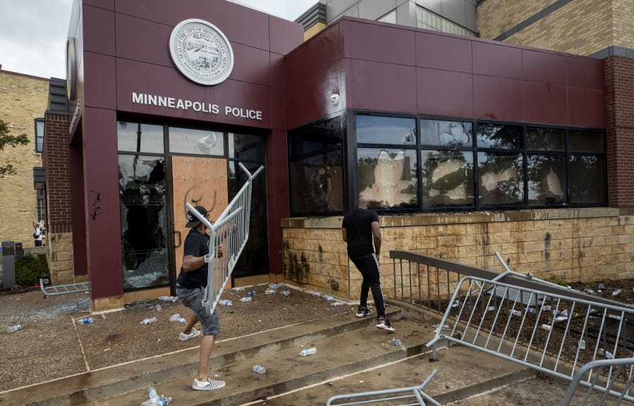 Protesters damage properties at the Minneapolis 3rd Police Precinct in Minneapolis on Wednesday, May 27, 2020. The mayor of Minneapolis called Wednesday for criminal charges against the white police officer seen on video kneeling against the neck of a handcuffed black man who complained that he could not breathe and died in police custody.