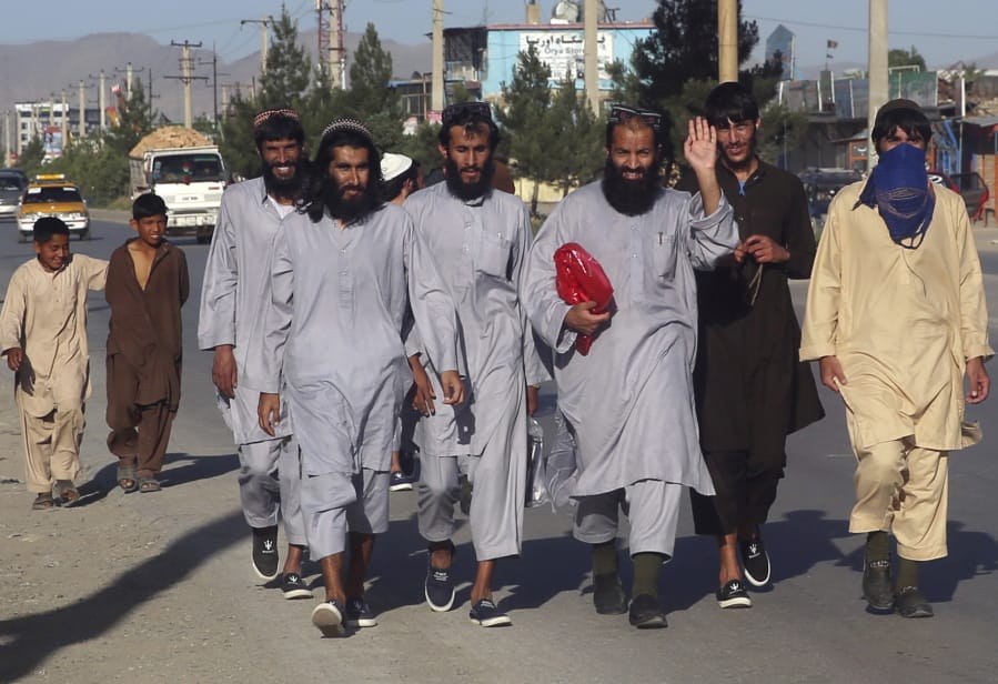 Afghan Taliban prisoners freed from Bagram Prison walk in Kabul, Afghanistan on Tuesday.