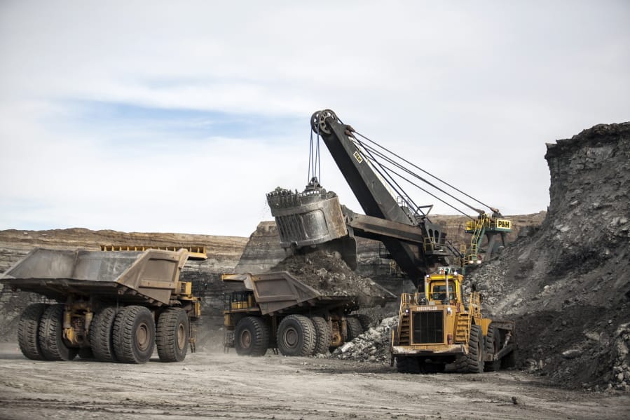 FILE - In this Jan. 9, 2014, file photo, a shovel loads haulers with coal at the Antelope Mine north of Douglas, Wyo. A coalition of U.S. states, environmentalists and an American Indian tribe are seeking to revive a moratorium on coal sales from public lands in the West.