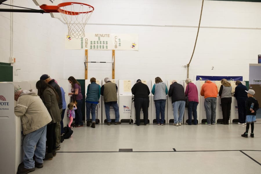 FILE - In this Nov. 6, 2018, file photo, voters cast their ballots at Collister Elementary in Boise, Idaho. On Tuesday, May 19, 2020, Idaho is holding an entirely mail-in primary for the first time as the state works to slow the spread of the coronavirus pandemic.