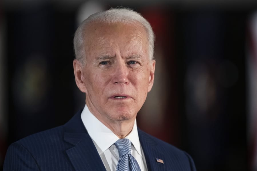 FILE - March 10, 2020, file photo, Democratic presidential candidate former Vice President Joe Biden speaks to members of the press at the National Constitution Center in Philadelphia. Biden is the presumptive Democratic nominee. But the process of making it official is anything but settled.
