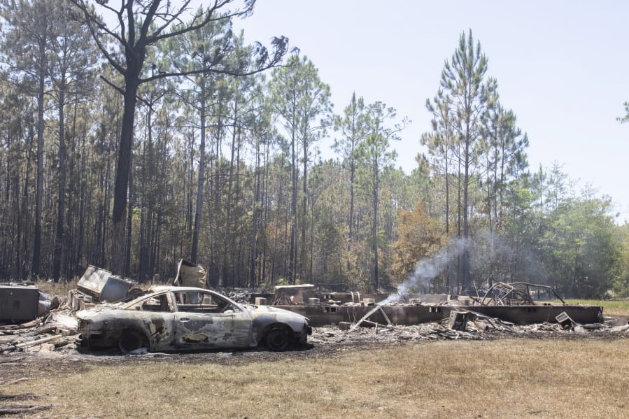 The foundation of a house in all that remains in the aftermath of the Five Mile Swamp Fire that is still burning near Milton, Fla., Thursday, May 7, 2020. Authorities say firefighters in the Florida Panhandle are battling wildfires that have forced some 1,600 people to evacuate from their homes.
