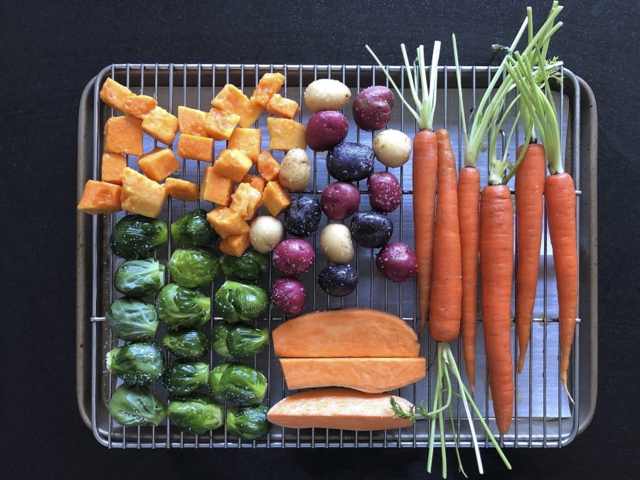 This March 2, 2020 image shows various vegetables placed on a rack prior to roasting in Amagansett, N.Y.  The key to roasting and grilling is having the natural sugars in the vegetables browned and caramelized, resulting in both great texture and flavor.