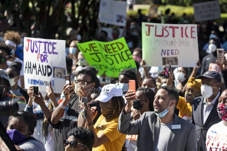 People react during a rally to protest the shooting of Ahmaud Arbery, an unarmed black man Friday, May 8, 2020, in Brunswick Ga. Two men have been charged with murder in the February shooting death of Arbery, whom they had pursued in a truck after spotting him running in their neighborhood.